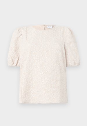 Top de manga bufante em bege claro com bordados florais. Apresenta um decote redondo e um fecho zip oculto nas costas. Tecido suave e texturizado.