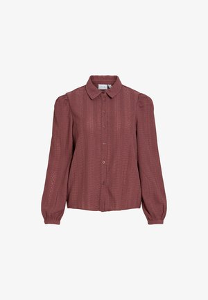 Blouse à manches longues couleur rose poudré avec tissu texturé, boutonnage à l'avant, poignets froncés et col pointu.