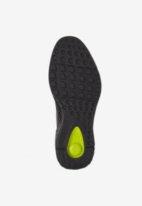 Sola di scarpa in gomma nera con un motivo di battistrada circolare, dotata di un accento verde sul tallone e di un design testurizzato per una maggiore aderenza.