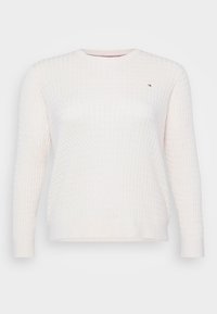 Maglione bianco con un motivo a diamante testurizzato, scollo rotondo e maniche lunghe. Presenta un piccolo logo sul petto. Materiale morbido.