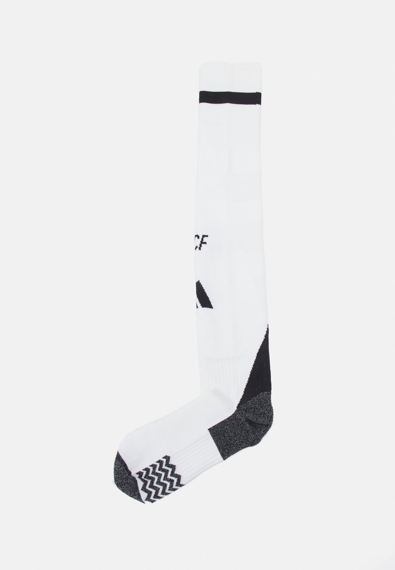 Calzino sportivo bianco con dettagli neri in cima e nel tallone. Presenta motivi texture e il marchio lungo il lato.