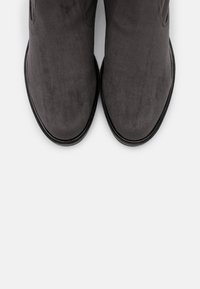 Gray suede ankle boots with a smooth texture, rounded toe, and flat rubber sole, viewed from above. No visible patterns or accents.