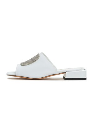 Sandali estivi bianchi con un accento argentato testurizzato, design open-toe, tacco basso a blocco e materiale liscio che mette in evidenza linee pulite.