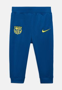 Μπλε αθλητικό παντελόνι από λεία ύφασμα, με κίτρινη κονκάρδα της FC Barcelona και μικρό κίτρινο λογότυπο Nike. Ελαστική μέση και μανσέτες.