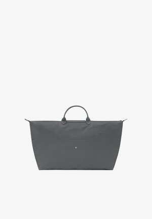 Large gray travel tote bag with two round handles and a central snap button closure on front pocket.