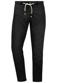 Los pantalones de algodón negros presentan una cintura con cordón y un botón de madera, corte ajustado y una textura suave. Diseño sencillo sin patrones notables.