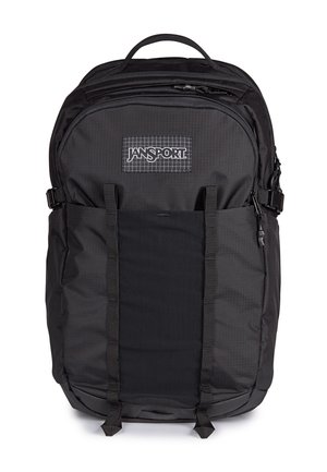 Sac à dos Jansport noir avec poignée supérieure, poche avant zippée, deux bretelles verticales et boucles de compression latérales.