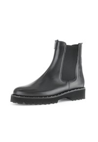 Zwarte leren enkelboots met elastische zijkanten, ronde neus, dikke gestructureerde zool en decoratieve stiksels langs de rand.