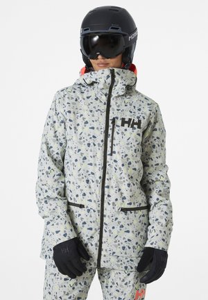 Ski jacket in a light grey with multicolored speckles, featuring a high collar, zip closure, and black accents. Worn with black gloves.