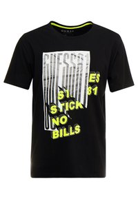Sort bomulds T-shirt med rund hals, der har fed hvid og neongul grafisk tekst, inklusive "GUESS" og "STICK NO BILLS."