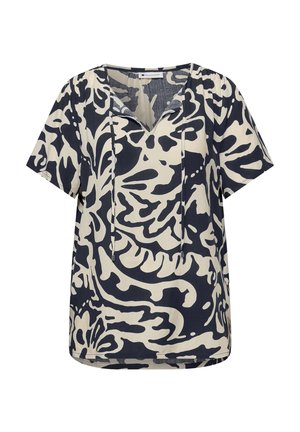 Blouse à manches courtes noire et blanche à motifs avec col en V et liens à nouer au niveau de l'encolure.