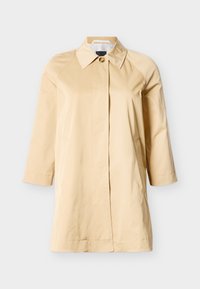 Μπεζ παλτό μέχρι το γόνατο με φαρδιά γιακά, κρυφά κουμπιά μπροστά και πλαϊνές τσέπες, παρουσιασμένο σε λευκό φόντο.