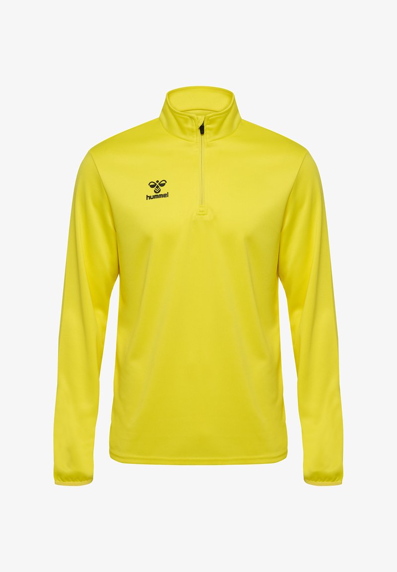 Heller gelber Langarm-Pullover mit einem halben Reißverschluss am Kragen. Mit einem schwarzen Logo auf der Brust. Hergestellt aus einem glatten, dehnbaren Stoff.