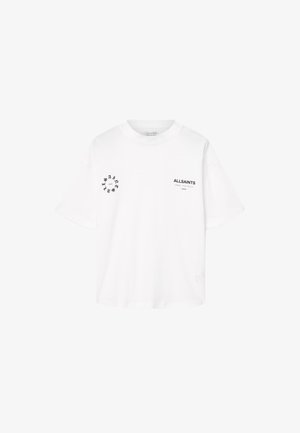 Balta trumpa rankovė T maročia iš medvilnės. Pirmoje ir kairėje rankovėje yra juodi spausdinti logotipai, su laisvu dėvėjimo stiliumi.