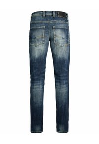 Jeans skinny fit in denim blu scuro con effetto slavato. Presentano tasche posteriori cucite e un'etichetta del marchio in pelle sulla vita.