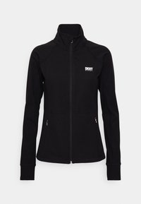 Svart zip-up jacka i mjukt, elastiskt tyg. Har en ståkrage, figurnära silhuett och två framfickor med dragkedja. DKNY Sport-logotyp på bröstet.