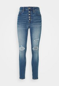 Högmidjade blå denimjeans med knapplåsing, som har slitna knälappar och en smal passform, med en urtvättad look och subtil textur.