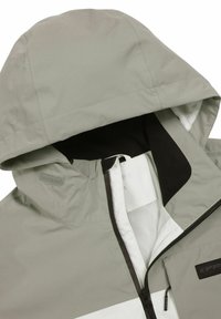 Ljusgrå vattentät jacka med huva, med ett nätfoder, svart dragkedja och vita randdetaljer. Mjuk textur med sömdetaljer.