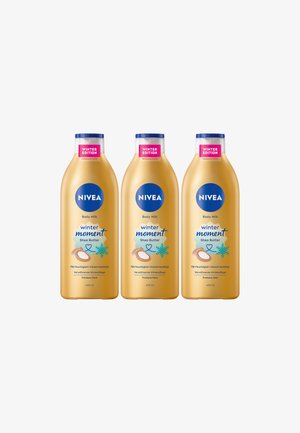 Three 400ml bottles of NIVEA Body Milk, golden with blue accents, labeled "Winter Edition" and featuring shea butter graphics.