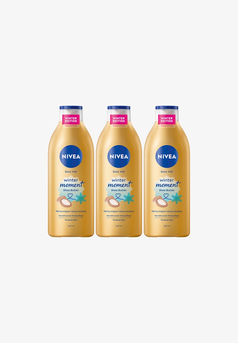 Three 400ml bottles of NIVEA Body Milk, golden with blue accents, labeled "Winter Edition" and featuring shea butter graphics.