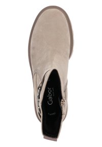 Beige ankle boots with a smooth suede texture, rounded toe, and side zipper. Rubber sole with subtle ridges for grip.