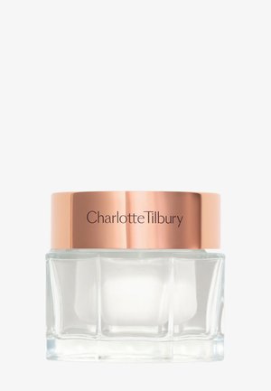 Bocal en verre transparent de forme rectangulaire, avec un couvercle métallique rose gold portant l'inscription "Charlotte Tilbury". Surface lisse, design minimaliste.