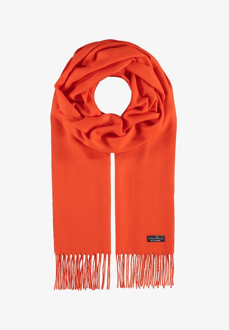 Écharpe en laine orange vif avec des extrémités à franges, disposée en boucle avec une petite étiquette de marque rectangulaire visible sur un côté.