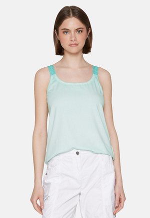 Mint green tank top with textured straps, soft fabric, relaxed fit, and a round neckline. Paired with white cargo shorts.