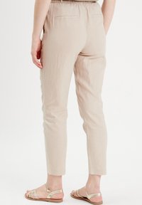 Cache Cache FLIESSENDE  - Pantalon classique - sable