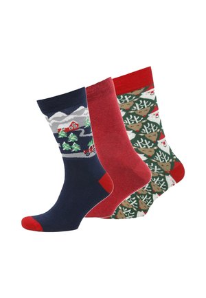 Three pairs of socks: navy with mountain scene, solid red, and green with reindeer and Christmas trees, featuring contrasting toe colors.