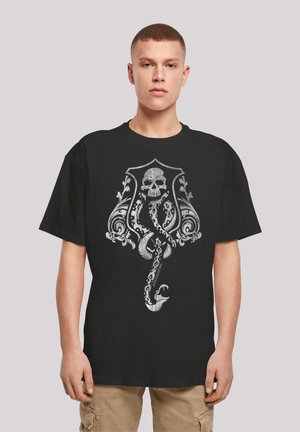 Black cotton t-shirt featuring a detailed silver graphic of a skull entwined with ornate designs and a serpent. Short sleeves and relaxed fit.