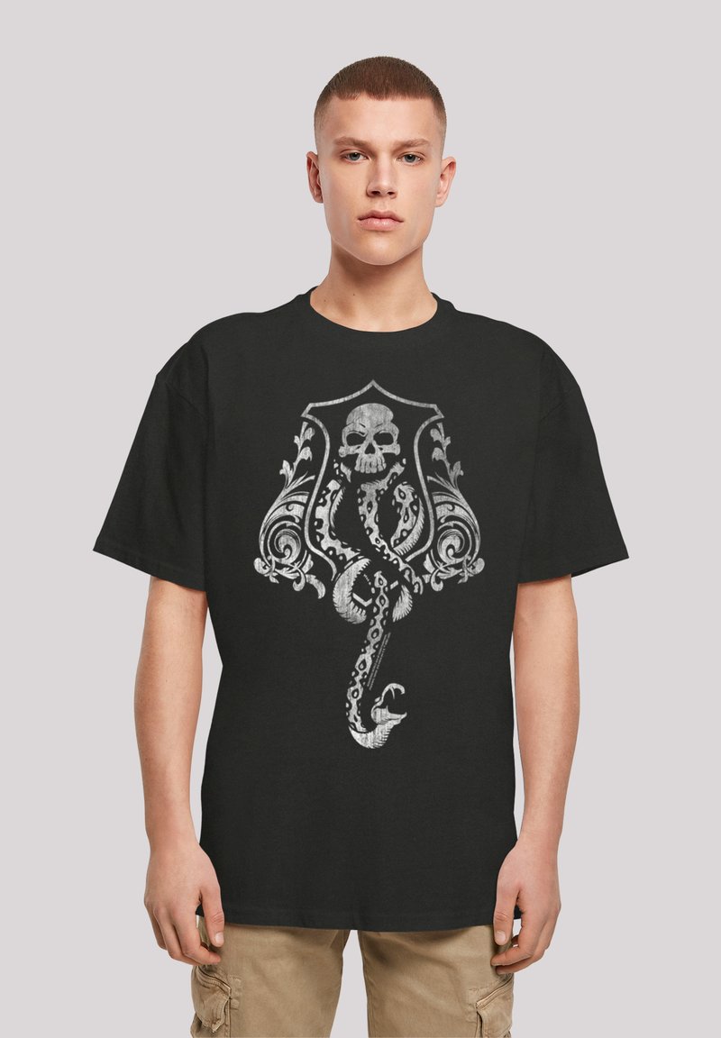 Black cotton t-shirt featuring a detailed silver graphic of a skull entwined with ornate designs and a serpent. Short sleeves and relaxed fit.