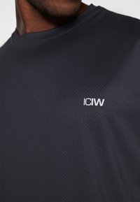 Dark navy athletic t-shirt featuring a textured surface and a white "ICIW" logo on the chest, round neck design.