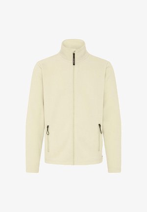 Šviesiai kreminės fleeco striukė su užtrauktuku priekyje, aukštu apykakle ir dviem šoninėmis kišenėmis. Yra juodos spalvos detalės ir lygi tekstūra.