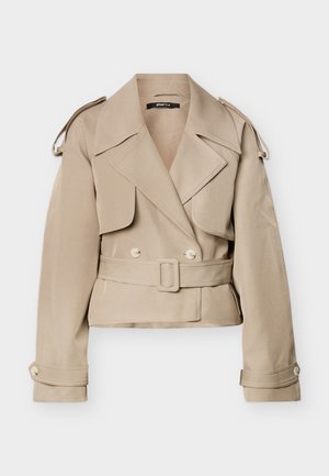 Μπεζ κοντό παλτό τρανς με φαρδιές πέτρες, διπλή σειρά κουμπιών, ζώνη στη μέση, επιθέματα στους ώμους και κουμπωτά μανίκια.