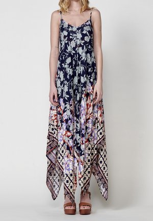 Blomstret maxikjole i navy med spaghettistropper, v-udskæring og høj-lav kant. Stoffet har en blanding af blomster og geometriske mønstre.