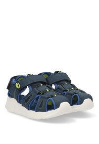 Sandalias de color azul marino con un diseño transpirable, que cuentan con correas ajustables de velcro, un acabado texturizado y una suela de goma blanca con acentos verdes.
