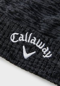 Melnā adīta cepure ar teksturētu rakstu. Uz priekšu ir redzams balts izš�ūts "Callaway" logo un emblēma.