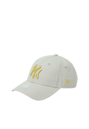 Cappellino da baseball beige con logo New York Yankees ricamato in oro sulla parte anteriore e logo New Era in oro sul lato.