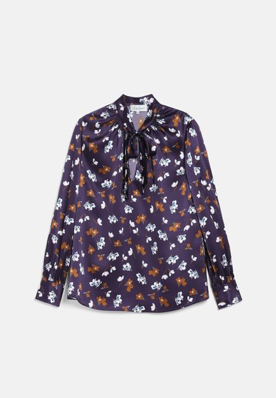Blouse violette à manches longues avec motif floral marron et blanc, encolure froncée, et détail nœud à l'avant.