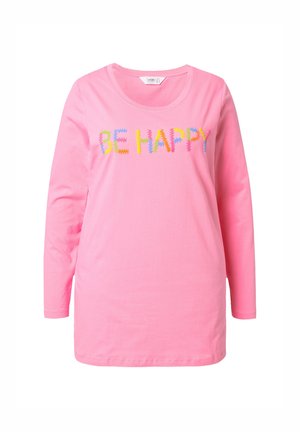 Camisa de manga larga rosa con cuello redondo, que presenta texto bordado multicolor "SE FELIZ" en la parte delantera. Material de algodón suave.