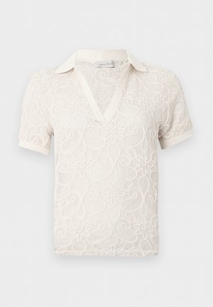 Haut court à manches courtes en dentelle avec motif floral, col en V et col, fabriqué en tissu léger et transparent.