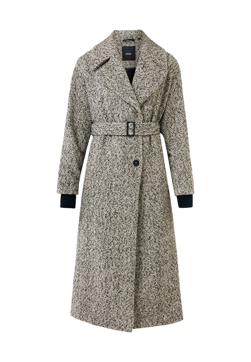 Hondstandpatroon jas met een ceintuur in de taille, grote revers en zijzakken; voornamelijk zwart en wit, met lange mouwen en gebreide manchet.