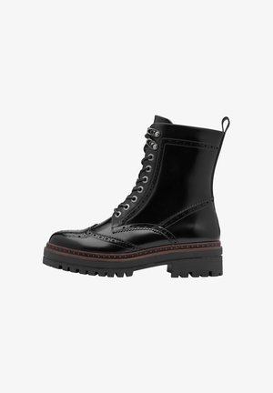 Schwarze Lederstiefeletten mit Broguedetails, Schnürung vorne und einer dicken Gummisohle. Verfügt über einen stabilen Absatz und eine Anziehschlaufe.