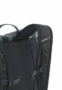 Mochila negra con correas acolchadas de malla para los hombros, con hebillas ajustables y un panel superior con textura. Etiqueta con el logo visible en la correa.