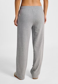 Szare dresy o luźnym kroju wykonane z miękkiego materiału. Posiadają elastyczną talię i boczne kieszenie oraz prostą nogawkę.