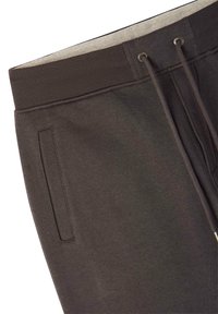 Ciemnobrązowe dresy z elastycznym pasem ze sznurkiem, kieszenią boczną i miękkim, teksturowanym materiałem.