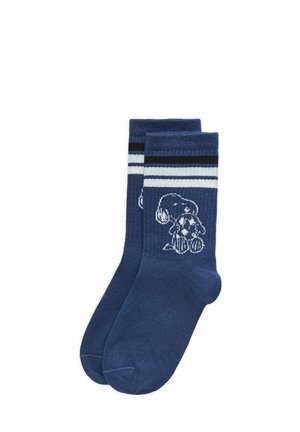 Blue crew socks with white and black stripes near the cuff, featuring a white cartoon dog holding a spotted ball on each sock.