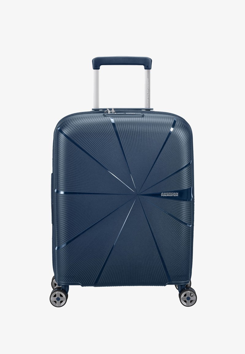 Valigia rigida blu navy con un design testurizzato, dotata di manico telescopico e quattro ruote girevoli per una facile manovrabilità.