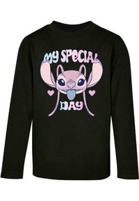Must musta särg, millel on cartooni tegelane, kellel on suured kõrva ja mänguline ilme. Tekst ütleb "MINU ERI PÄEV" värvilises kirjas.
